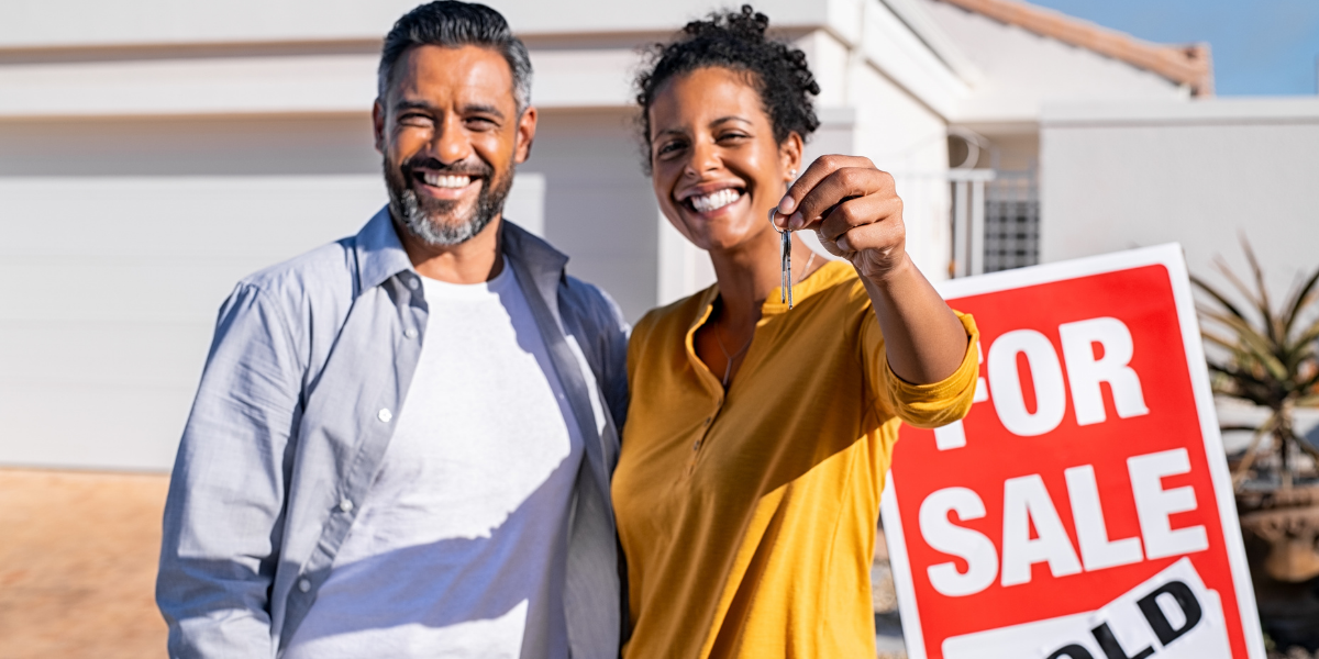 MLT_HomebuyersClosingonaHouseDosDonts happy couple holding keys in front of new home